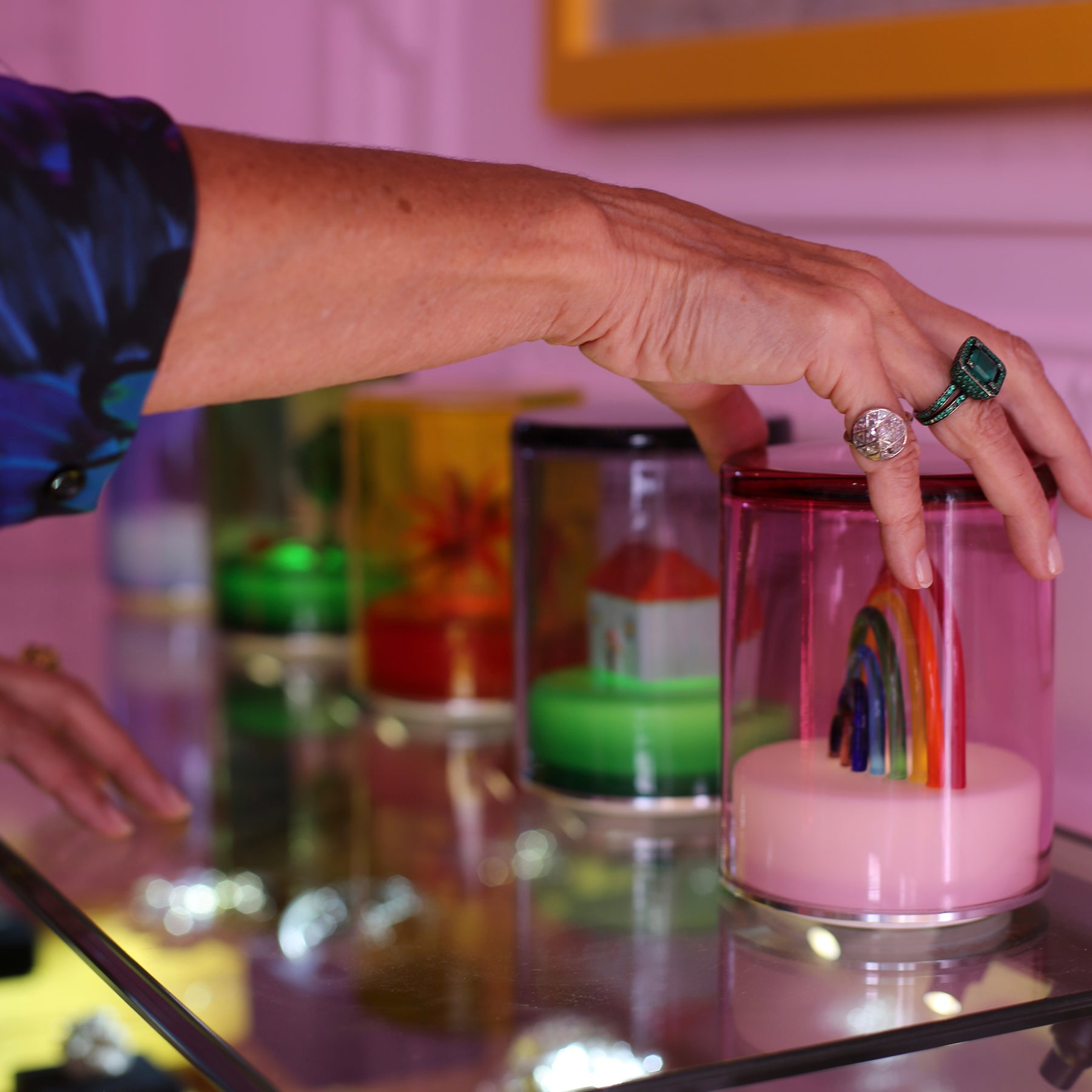 Rainbow Murano glass lamp designed by British designer Solange Azagury-Partridge in collaboration with Green Wolf Lighting. Shot with model hands wearing jewellery.