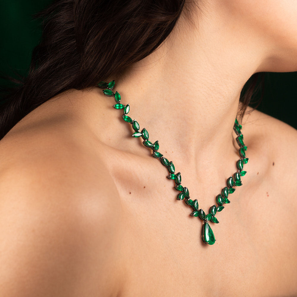 An old fashioned marquise emerald necklace with a pear shaped emerald drop in blackened 18 karat white gold by Solange Azagury-Partridge On Model Side