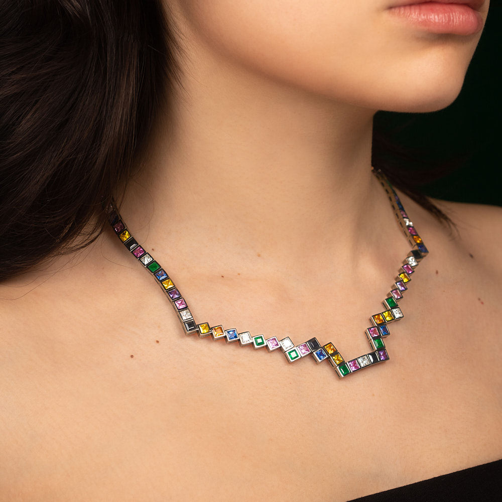 A random layout of square and princess cut Diamonds, coloured Sapphires, Rubies and Emeralds skinny necklace in blackened 18 karat white gold by Solange Azagury-Partridge On Model
