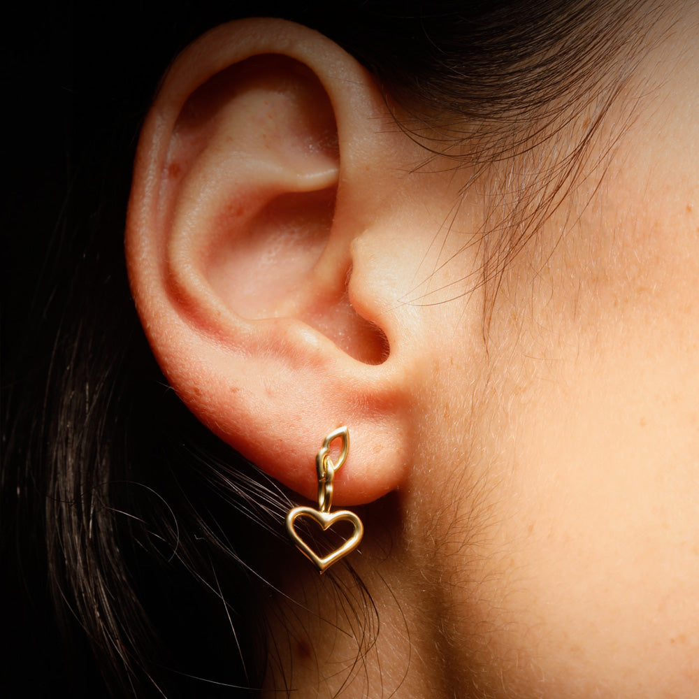 The Love and Kisses chain Earrings by designer Solange Azagury-Partridge - 18 carat Yellow Gold - on model shot