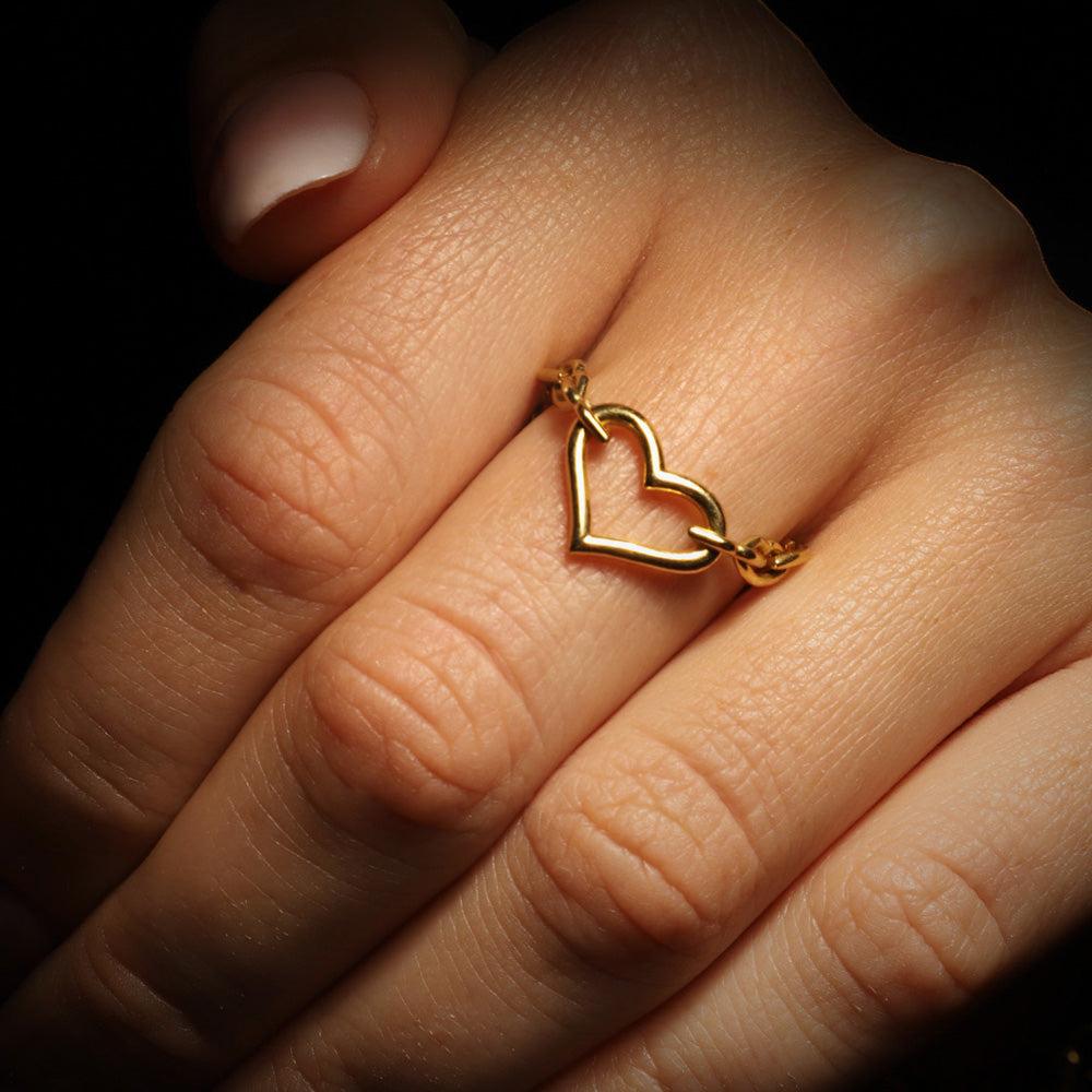 The Love and Kisses chain ring by designer Solange Azagury-Partridge - 18 carat Yellow Gold - front view on model hand