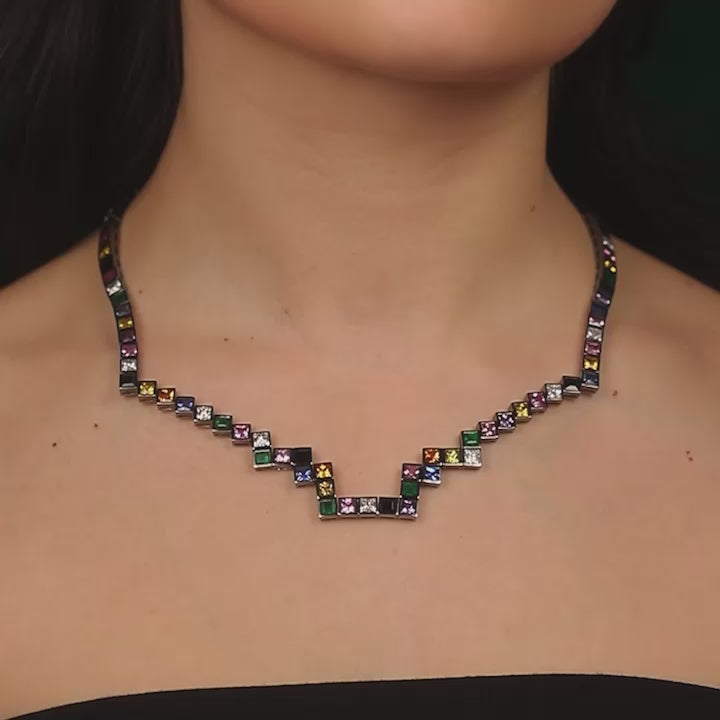 A random layout of square and princess cut Diamonds, coloured Sapphires, Rubies and Emeralds skinny necklace in blackened 18 karat white gold by Solange Azagury-Partridge Video On MOdel