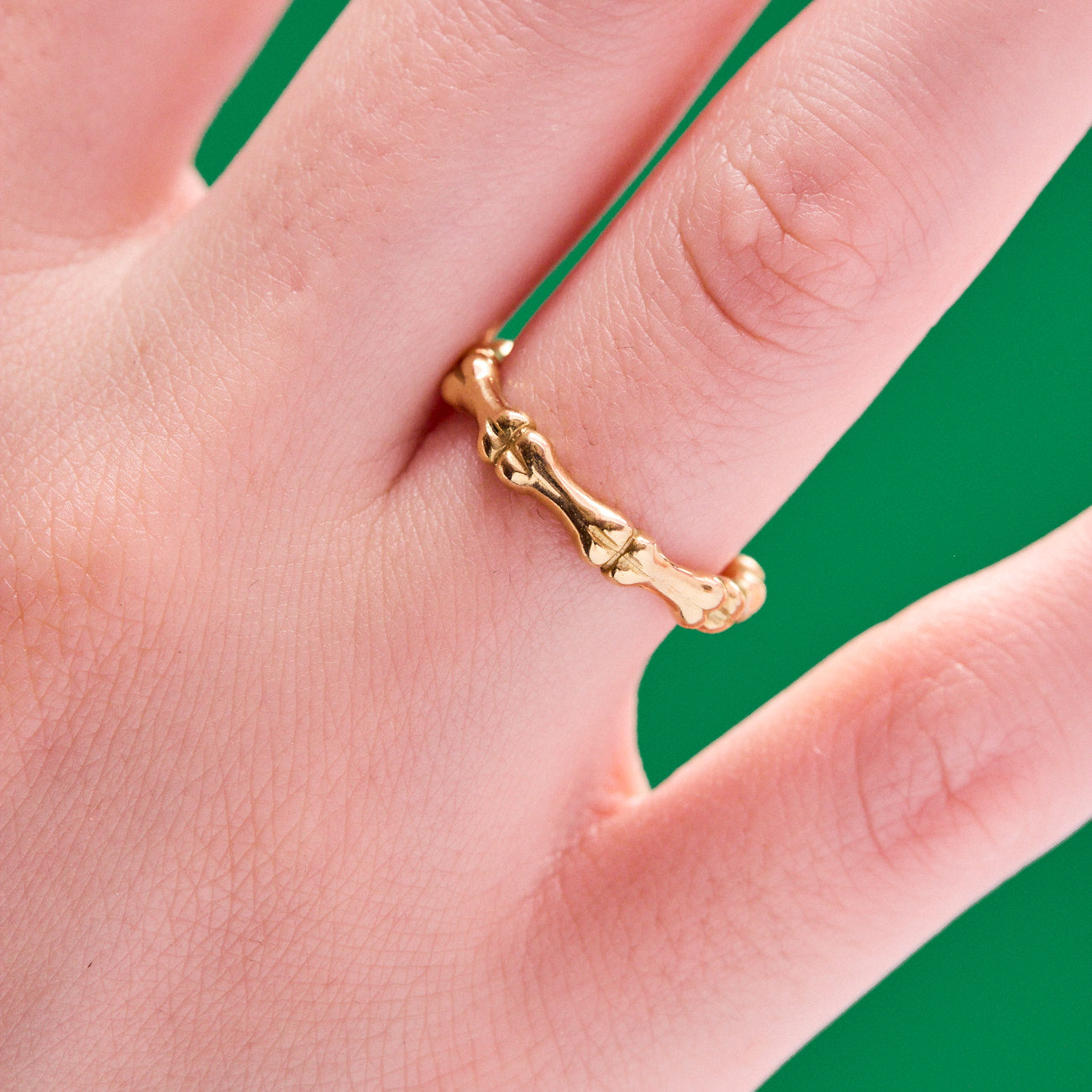 Bones Motif Wedding Band Ring made from 18 karat yellow gold by Solanage Azagury-Partridge on hand