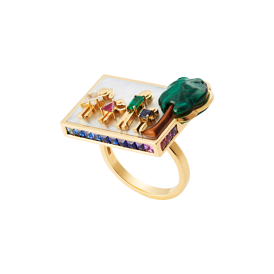 A family plaque ring composed of a family and a tree in diamond, ruby, emerald, sapphire, malachite and tigers eye set on a bed of mother of pearl surrounded by invisibly set sapphires, rubies, and emeralds in 18 karat yellow gold by Solange Azagury-Partridge