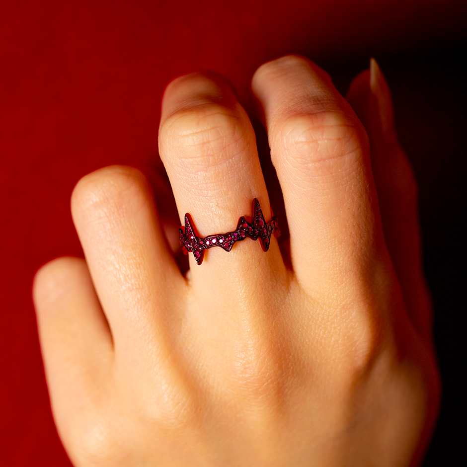 Heartbeat motif ring made from rubies and red ceramic plated yellow gold by Solange Azagury-Partridge on hand