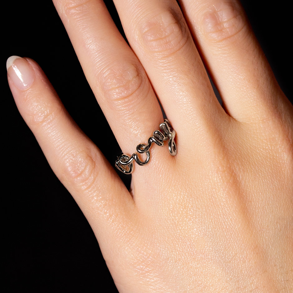 Marry Me Word Ring made from wire curved into the words of marriage proposal 18k yellow gold by Solange Azagury-Partridge on hand
