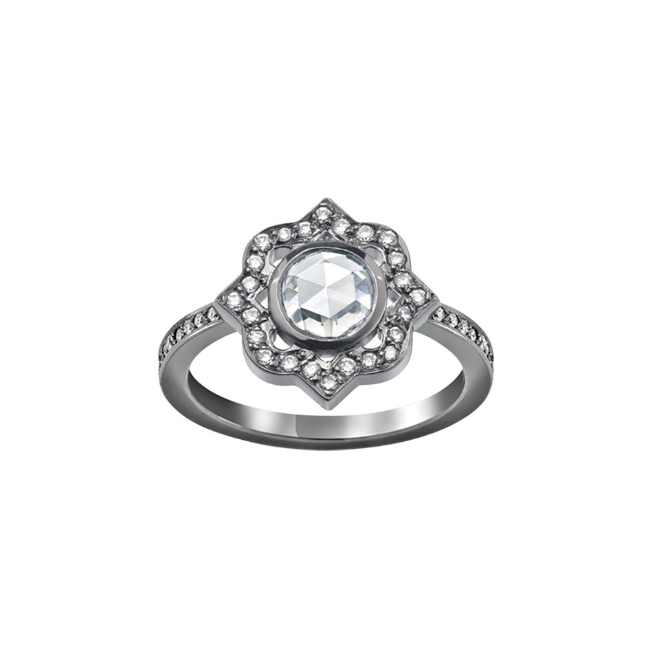 A ring with a rose cut diamond centre surrounded by brilliant cut diamonds and a diamond set shank in blackened 18 karat white gold by Solange Azagury-Partridge