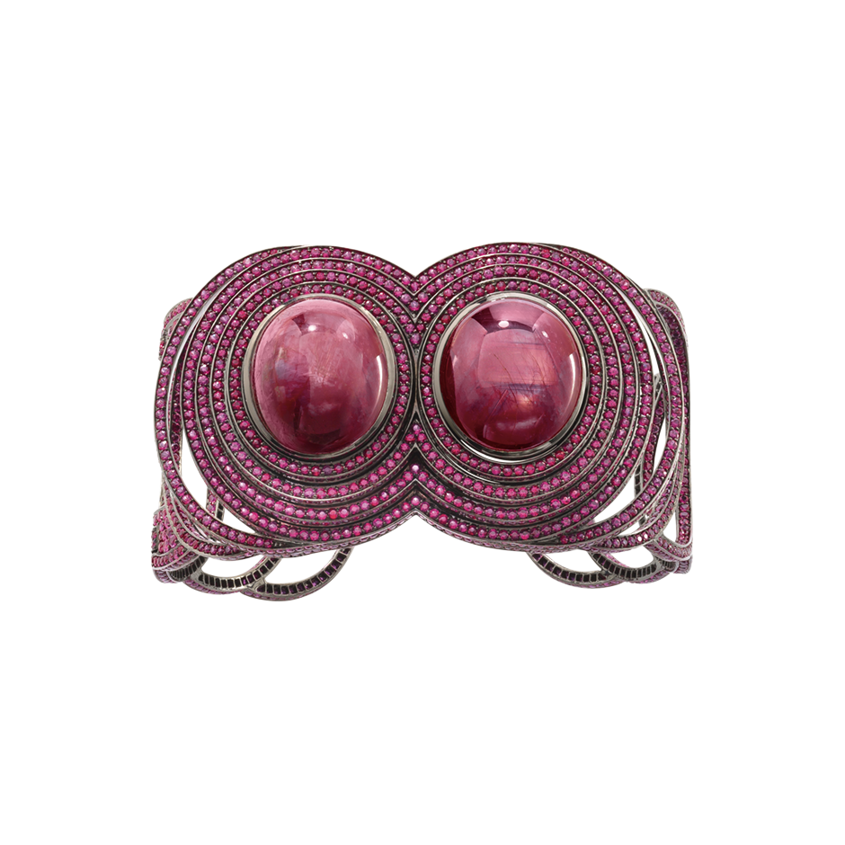  An open  work cuff composed of twin star and cabochon rubies with rubies pavé surrounded set in blackened 18 karat white gold by Solange Azagury-Partridge