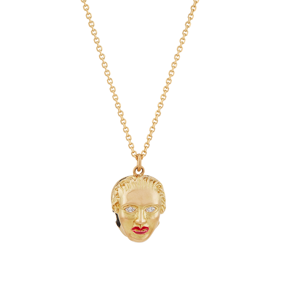A pendant that respects the inevitability of death, half skull and half human face with diamond eyes and ruby red lacquered lips set in 18 karat yellow gold pendant on a chain by Solange Azagury-Partridge