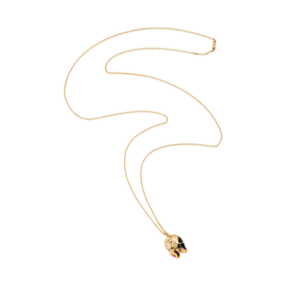 A pendant that respects the inevitability of death, half skull and half human face with diamond eyes and ruby red lacquered lips set in 18 karat yellow gold pendant on a chain by Solange Azagury-Partridge