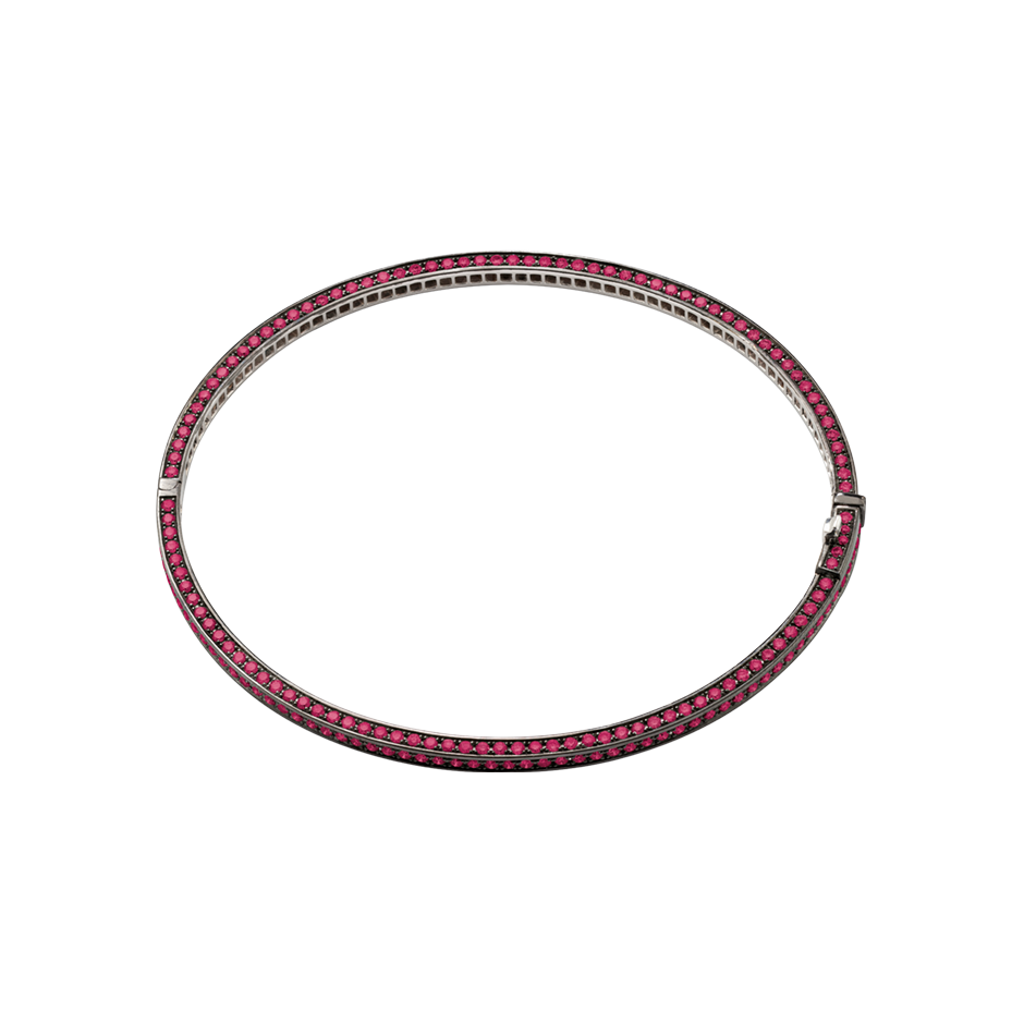 A bangle set on three sides with brilliant cut rubies in blackened 18 karat white gold by Solange Azagury-Partridge