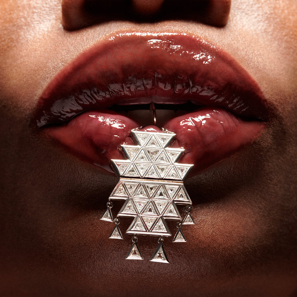 Nimrod triangle diamond and 18 karat white gold earring hanging from teeth by Solange Azagury-Partridge