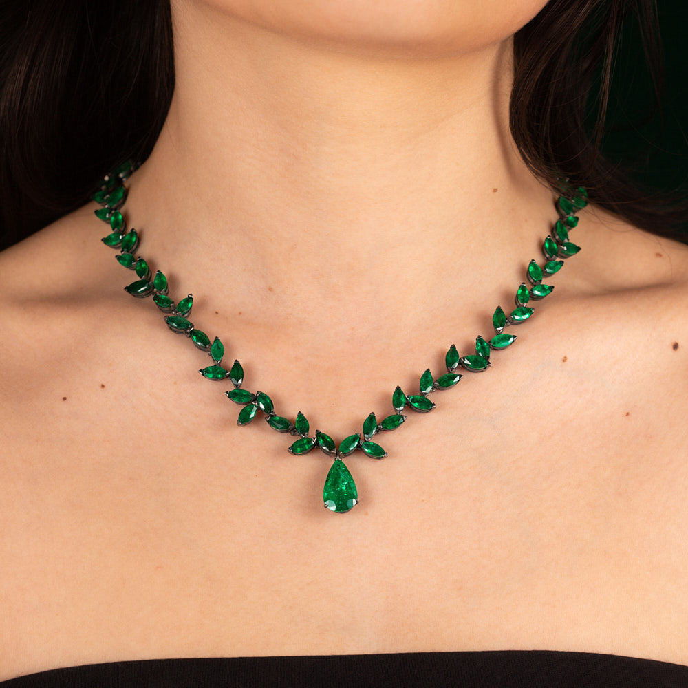 An old fashioned marquise emerald necklace with a pear shaped emerald drop in blackened 18 karat white gold by Solange Azagury-Partridge On Model Front
