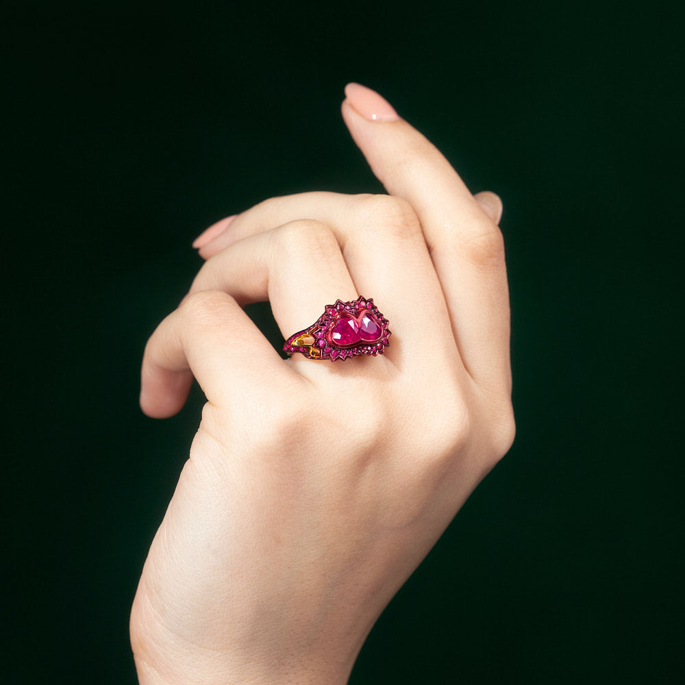 A ring composed of two heart shaped rubies supported by pavé set ruby heartbeat with red lacquer and ceramic plate set in 18 karat rose gold by Solange Azagury-Partridge On hand
