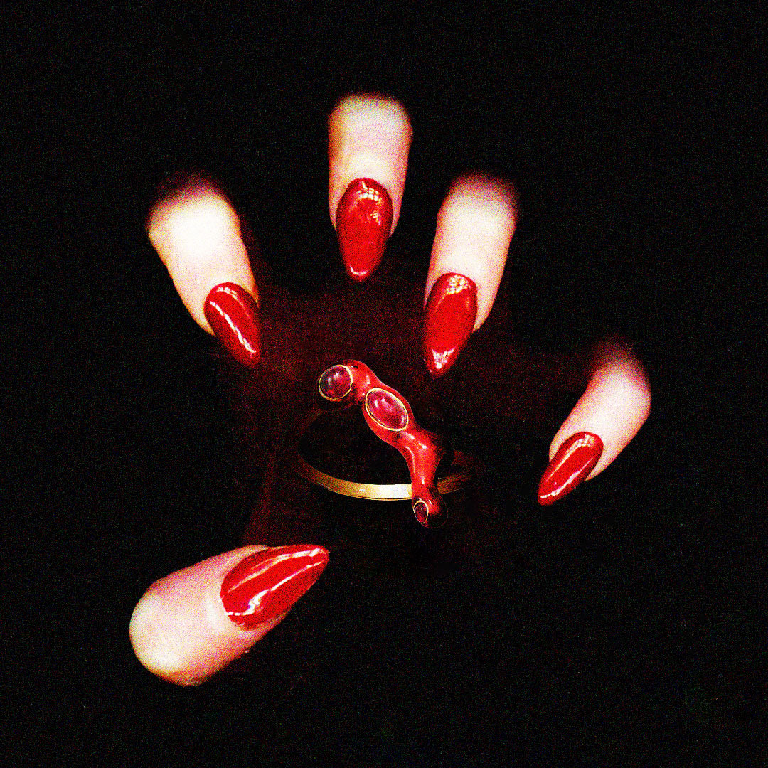 Ballcrusher ring gripped by a red manicured hand by Solange Azagury-Partridge