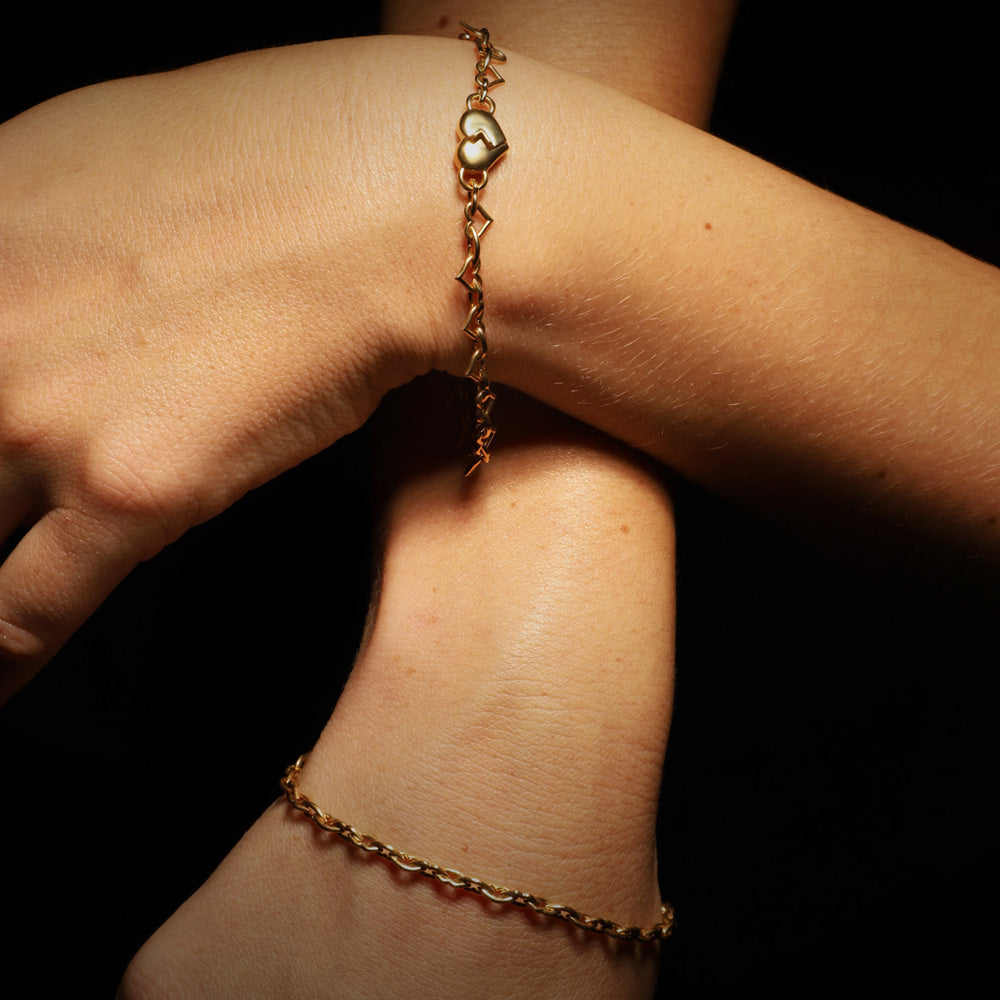 The Lots of Love and Kisses chain bracelet by designer Solange Azagury-Partridge - 18 carat Yellow Gold - on model styling