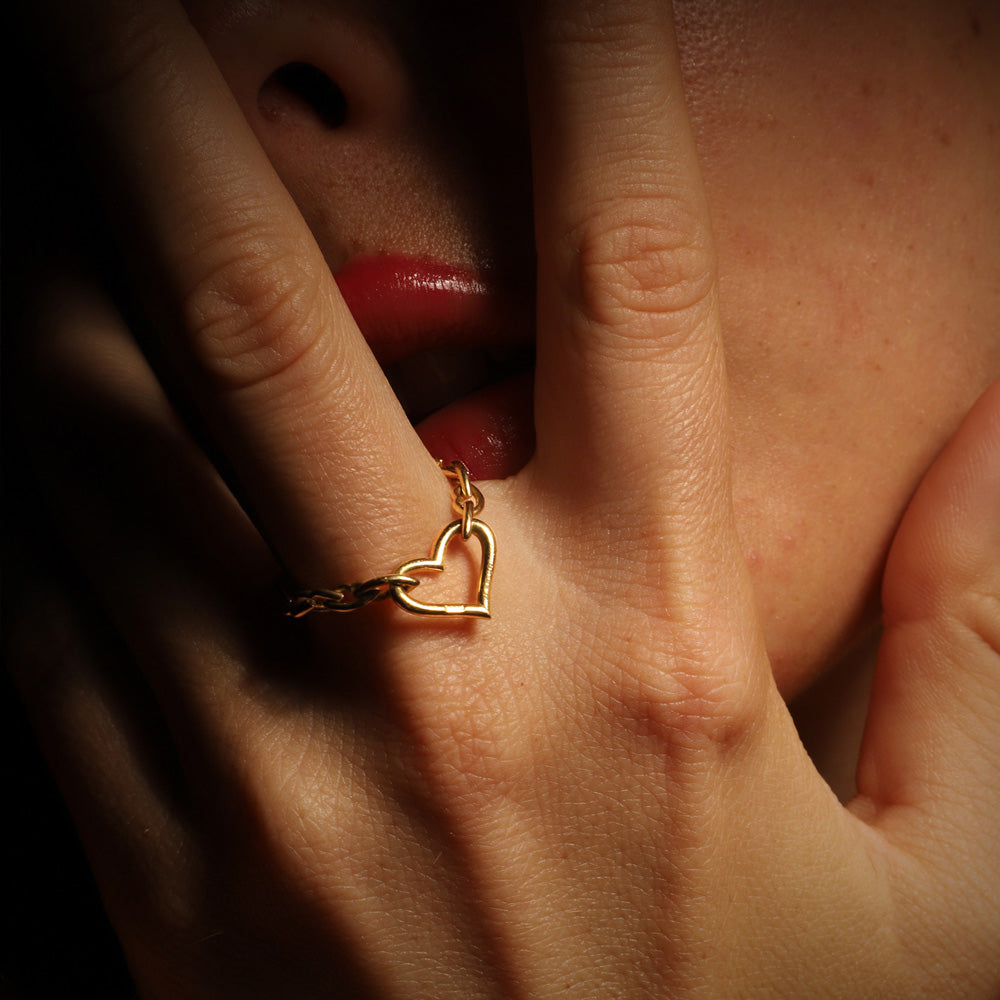 The Love and Kisses chain ring by designer Solange Azagury-Partridge - 18 carat Yellow Gold - front view on model