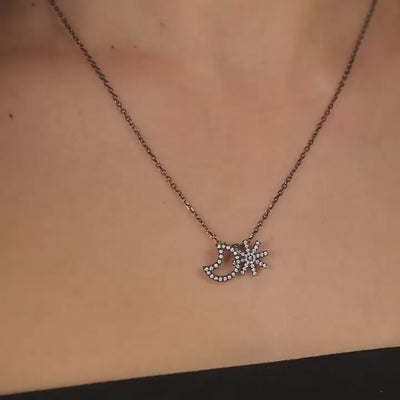 A moon and star motif pendant set with brilliant cut diamonds in blackened 18 karat white gold by Solange Azagury-Partridge Video