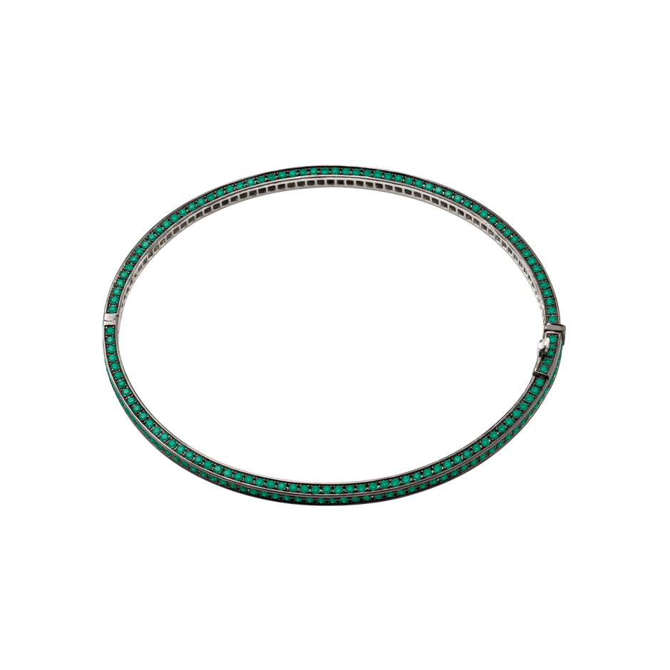 A bangle set on three sides with brilliant cut emeralds in blackened 18 karat white gold by Solange Azagury-Partridge