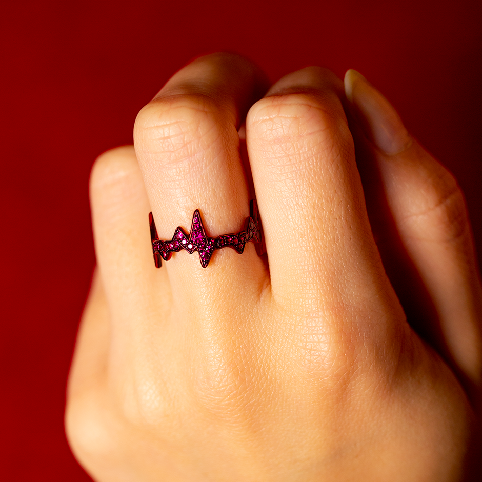 Heartbeat motif ring made from rubies and red ceramic plated yellow gold by Solange Azagury-Partridge on hand