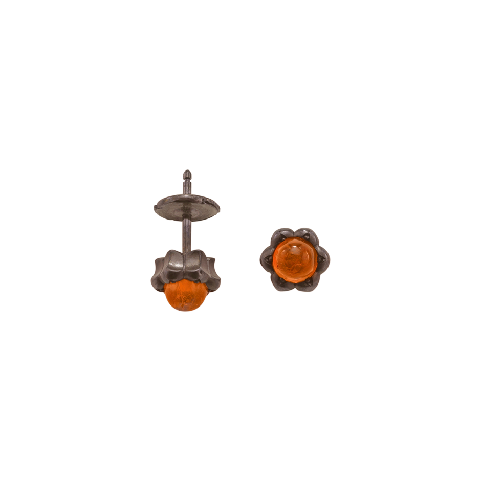 A pair of lotus motif stud earrings set with round cabochon fire opal in blackened 18 karat white gold by Solange Azagury-Partridge