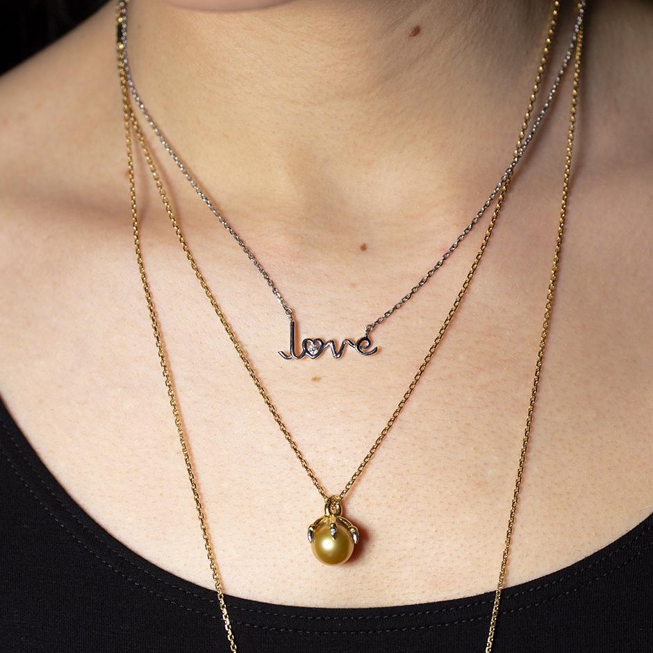 Love Written word pendant necklace 18k white gold by Solange Azagury-Partridge on model with ballcrusher necklace