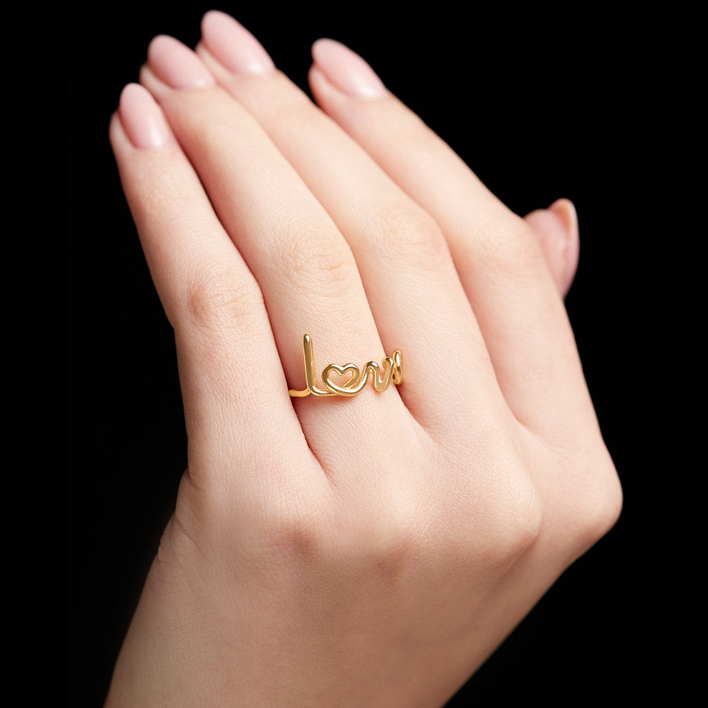 Love Written Word Ring In 18 karat Yellow Gold by Solange Azagury-Partridge On Models Hand