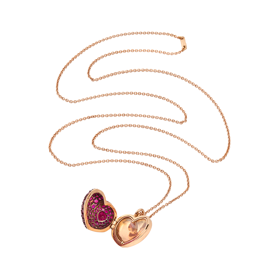A locket that both celebrates a love for a partner and keeps it private all at once set with rubies, red ceramic plate with a sapphire glass hidden storage compartment on a chain set in 18 karat rose gold by Solange Azagury-Partridge