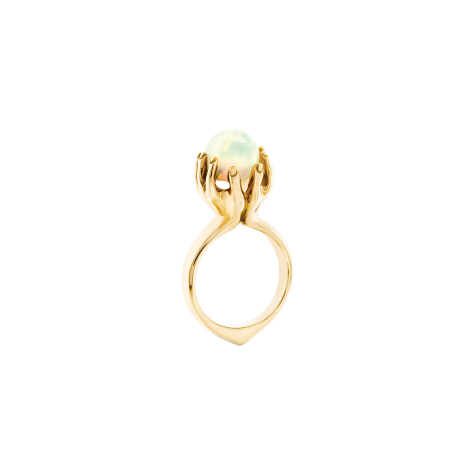 Offering ring with two outstretched hands holding an opal in 18 karat yellow gold by Solange Azagury-Partridge