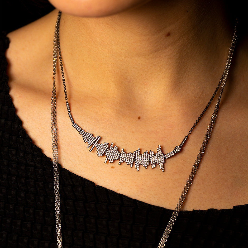 Diamonds and 18 karat white gold audio soundwave necklace representing the words "Where True Love Burns Desire is Love's Pure Flame" by Samuel Taylor-Coleridge on model